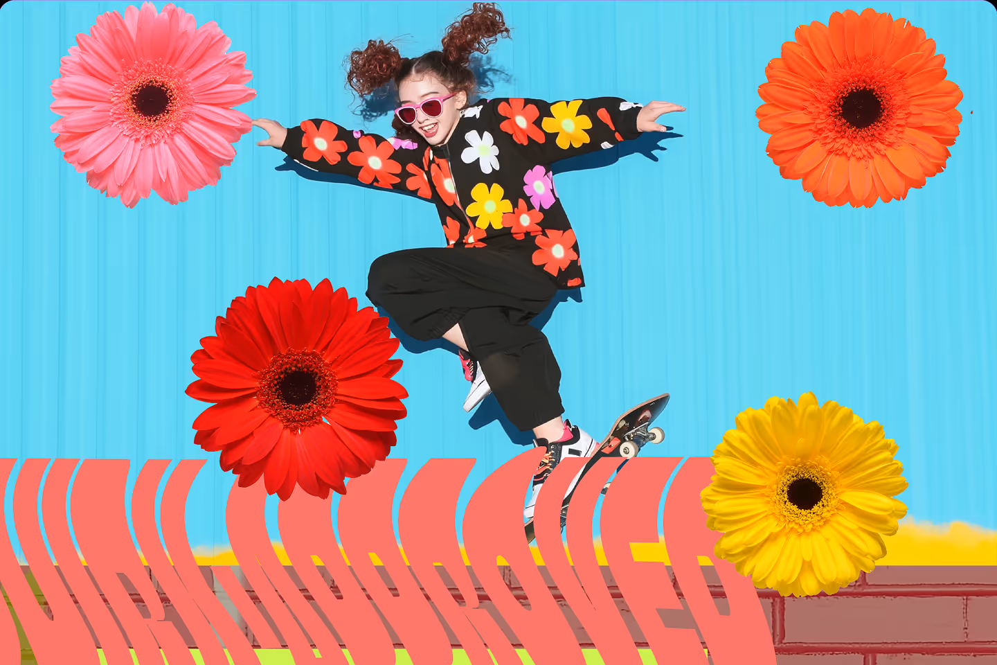 A young girl in a colorful floral-patterned jacket performing a skateboard trick against a blue backdrop decorated with oversized, vibrant flowers.